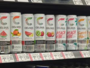 Celsius energy drink cans on store shelf.