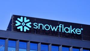 Snowflake logo on building against blue sky