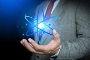 Person holding glowing atomic model hologram