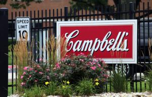 Campbell's sign with flowers and speed limit sign.