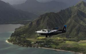 Joby Aviation eVTOL flying with water and mountains in the background