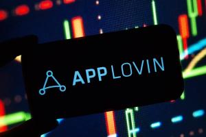 AppLovin logo on screen colorful stock chart background