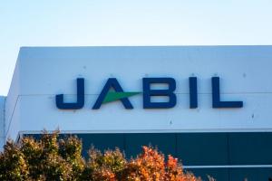 Jabil logo on building facade trees in foreground