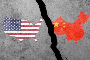USA and China flags on a concrete wall. USA and China trade, tariffs war. China and United States of America trade competition.