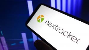Nextracker logo on phone screen with chart in background