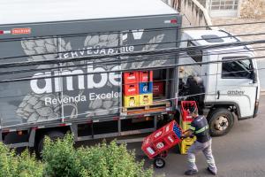Man iunloading drinks from a Ambev beverage truck on a street in Brazil