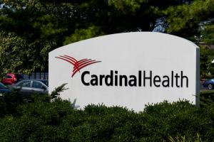 Large white Cardinal Health sign in front of office parking lot in Indianapolis.