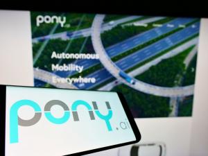 Cellphone with Pony AI Inc logo on screen in front of website Focus