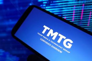 trump media log on smartphone screen against a computer screen