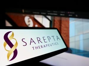Sarepta Therapeutics Inc. on screen in front of business website. Focus on left of phone display.