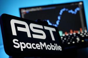 AST Spacemobile Company Logo on Mobile Device with Stock Chart Blue LED Background Vibrant