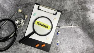 Concept of Hemophilia write on sticky notes isolated on Wooden Table.