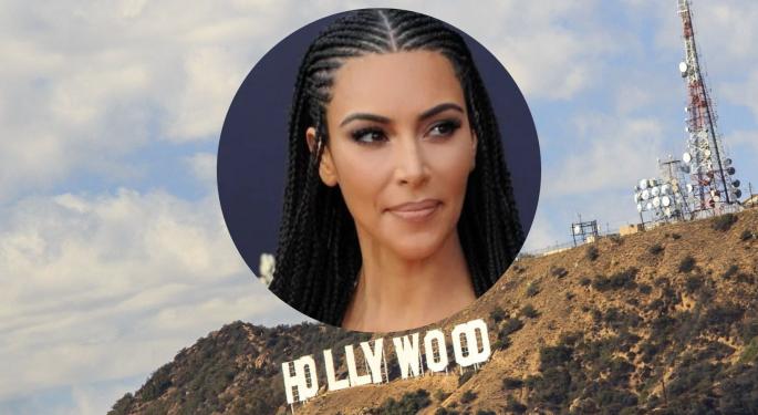 Benzinga Buzz: Kim Kardashian And This QB Great Bid Millions At Jay-Z's Charity Auction