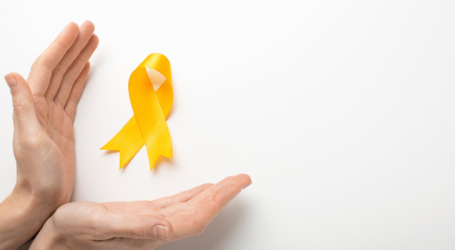 view yellow ribbon with human hands